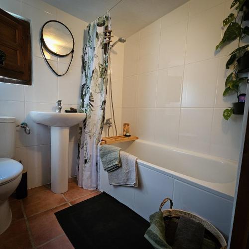 a bathroom with a tub and a sink and a toilet at Cortijo El Ancla in Albox