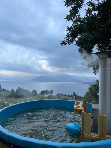 a pool of water with chairs in it at Cabaña el tilo in Lago Ranco