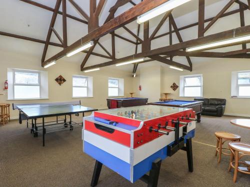 a room with two tables and ping pong tables at 26 Manorcombe in Callington