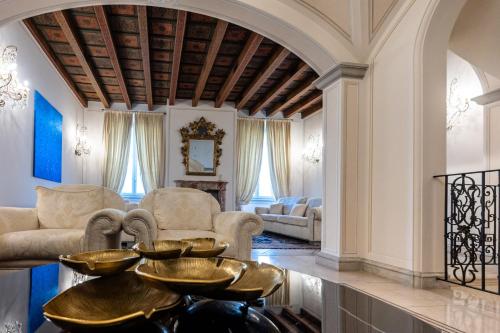 a living room with two tables and a couch at Palazzo Porta Picta in Bergamo
