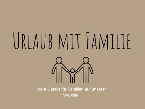 two people holding hands under the words turub mkt family at Hotel Talhof Garni&more in Wängle bei Reutte in Reutte