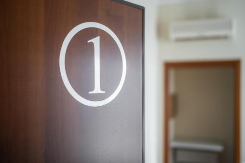 a door with the number one on it next to a doorway at Residence Due Spade - Free Parking in Melzo