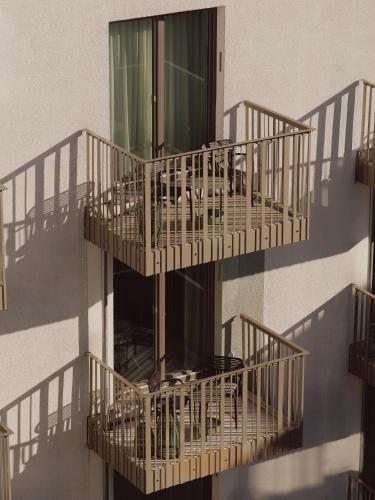 a building with four balconies on the side of it at Schwan Locke in Munich