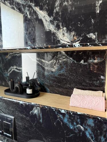 a bathroom with a black marble wall at Villa ander in Hammamet