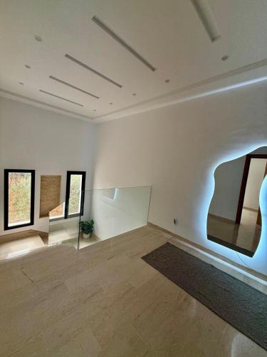 an empty room with two pieces of art on the wall at Villa ander in Hammamet