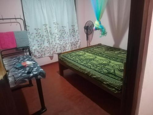a room with a bed and a chair and a window at My room at Galle in Galle