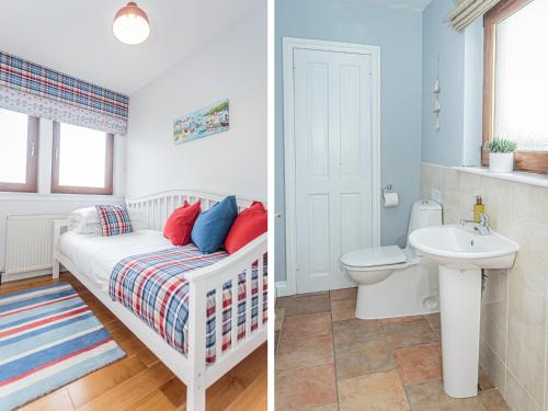 a bathroom with a bed and a toilet and a sink at Corsewall Castle Farm Lodges in Kirkcolm