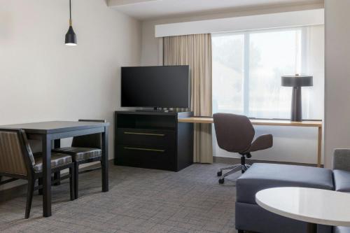 a hotel room with a desk and a tv and a couch at Residence Inn by Marriott Novato Sonoma in Novato