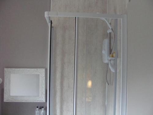 a shower with a glass door in a bathroom at Riggend Farm Bed and Breakfast in Airdrie