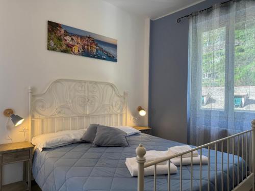 Postel nebo postele na pokoji v ubytování Pippo a Vernazza Rooms