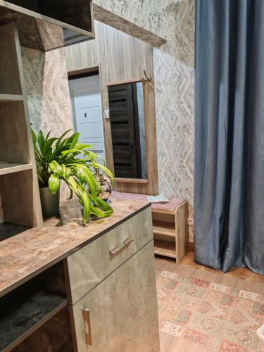 a kitchen with a sink and a mirror at Hotel Home in Tashkent