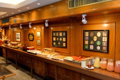 a buffet line with different types of food on display at North Savassi in Belo Horizonte