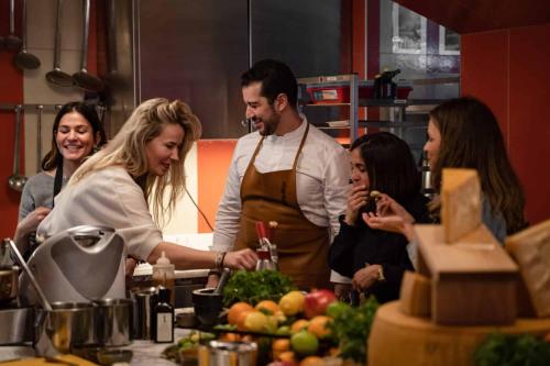 a group of people standing in a kitchen preparing food at Brach Paris - Evok Collection in Paris