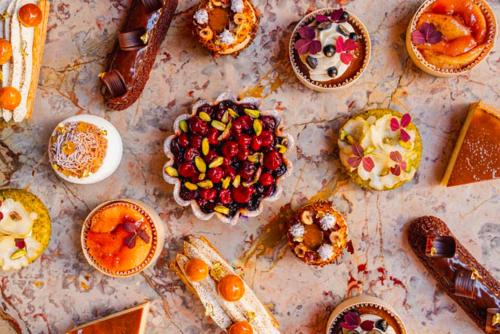 a table with many different types of food on it at Brach Paris - Evok Collection in Paris