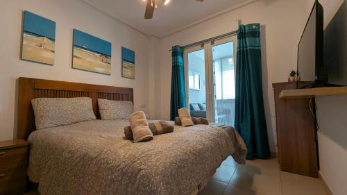 a bedroom with a bed with two pillows on it at Hacienda Apartment in Sucina