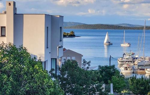 a sail boat in a harbor with boats in the water at Beautiful Apartment With Pool in Žman