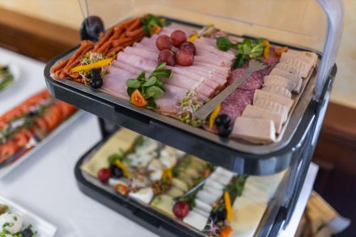 a display case filled with different types of food at Hotel Opera in Sopot