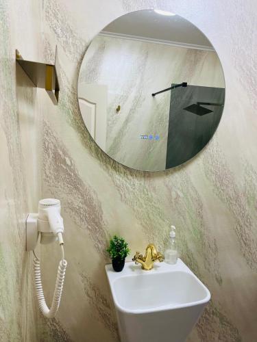 a bathroom with a sink and a mirror at Perla Muresului in Alba Iulia