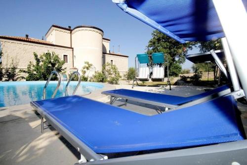 a blue bench next to a swimming pool at Villa Rezevici in Katun