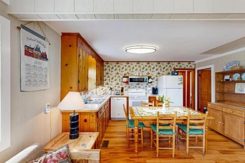a kitchen with a table and chairs in a room at Sea View 44 in Avon