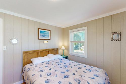 a bedroom with a bed and a window at Sea View 44 in Avon