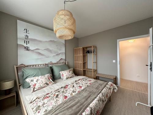 a bedroom with a bed and a chandelier at Sady, 5min from Airport and parking in Bratislava