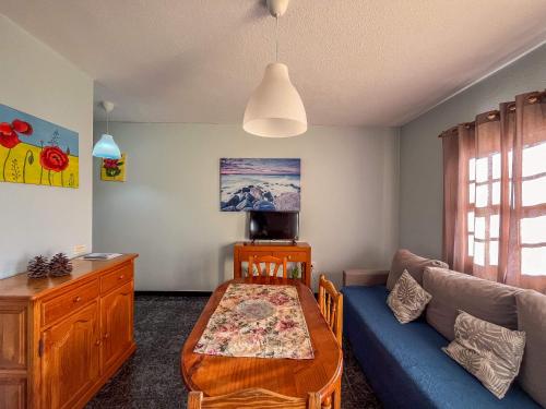 a living room with a couch and a table at Lightbooking Luymar con piscina Villa de Mazo in Villa de Mazo
