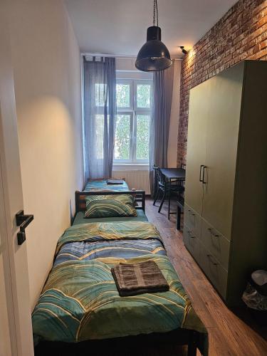 a bedroom with two beds and a window at 8Wygodny pokój w centrum Wrocławia in Wrocław