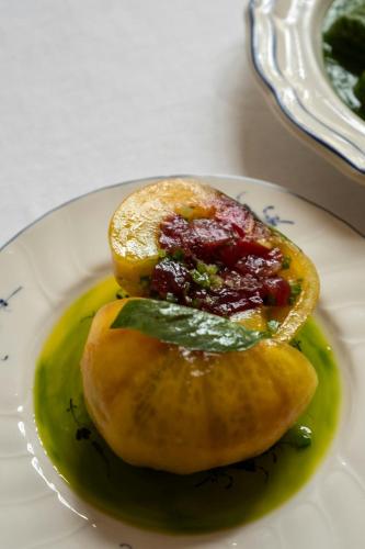 a plate of food with a piece of fruit and sauce at Hôtel du Couvent, a Luxury Collection Hotel, Nice in Nice