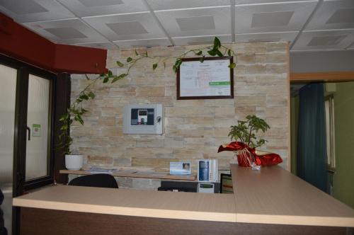 an office with a stone wall and a desk at Hostal Conde David in Salamanca