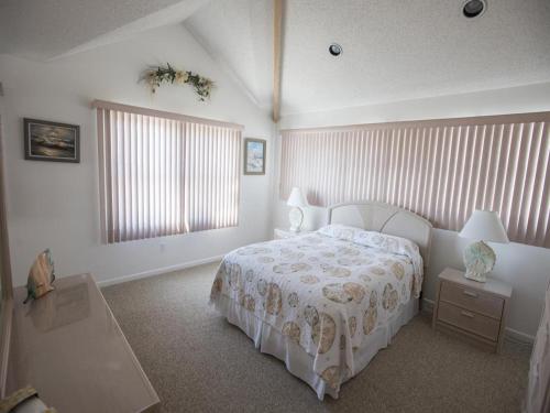 a bedroom with a white bed and a window at Ocean Front, Wi-Fi, Atlantic Views, 10 Beach Badges And Chairs, Outdoor Shower, Jacuzzi-Jet Tub, Decks Ping Pong Table, Private Yard,ship Bottom, in Ship Bottom
