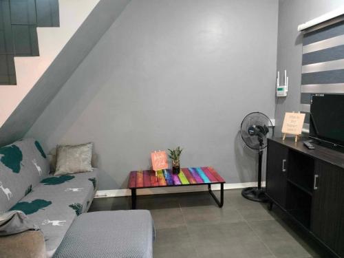 a living room with a couch and a table at 2 Bedroom House in Camella Carcar Cebu in Can-asujan