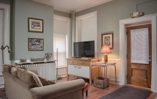 a living room with a couch and a television at Shamokin Bed and Breakfast in Shamokin