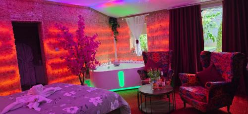 a bedroom with a tub and a bed and a table at APARTAMENT Solny SPA in Rzeszów