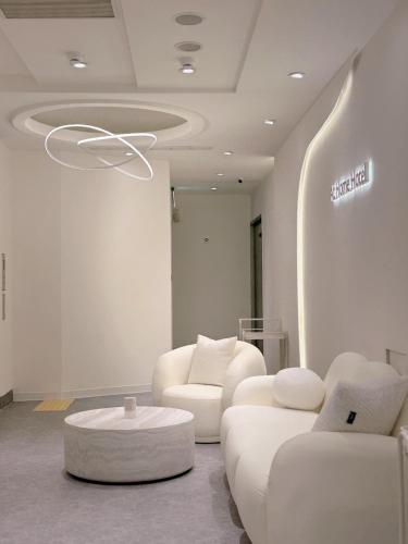 a living room with two white couches and a table at 在家行旅 南西館 in Taipei