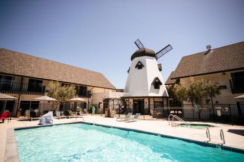 a swimming pool in front of a windmill at Sideways Inn in Buellton