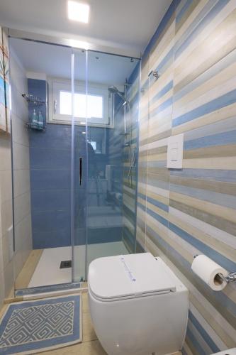 a bathroom with a toilet and a glass shower at Il Sogno in Erchie