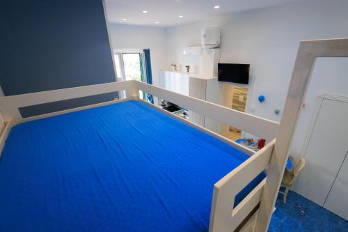 a bedroom with a bunk bed with blue sheets at Il Sogno in Erchie
