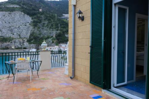 a patio with a table and chairs on a balcony at Il Sogno in Erchie