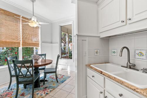 kuchnia ze stołem, krzesłami i zlewem w obiekcie Camp Seabreeze w mieście Inlet Beach