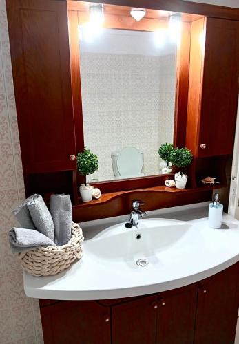 a bathroom with a sink and a mirror at Rumi's Paros house in the heart of Parikia in Parikia