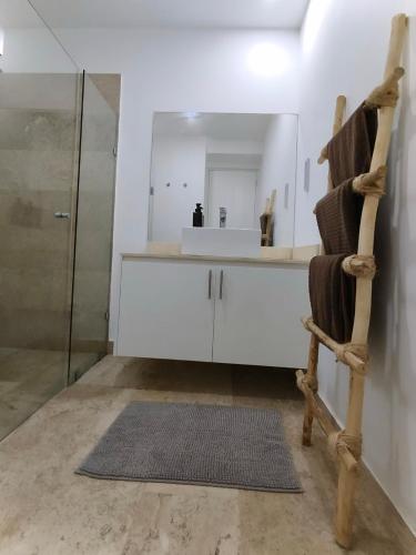 a bathroom with a wooden chair and a sink at Oceanfront 2Bed - 2Bath Paradise Mahahual in Mahahual