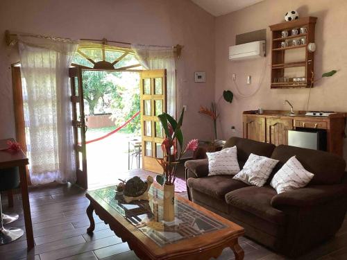 a living room with a couch and a coffee table at cabin Claro luna orchard, swimming pool 70mbps wifi in La Esperanza