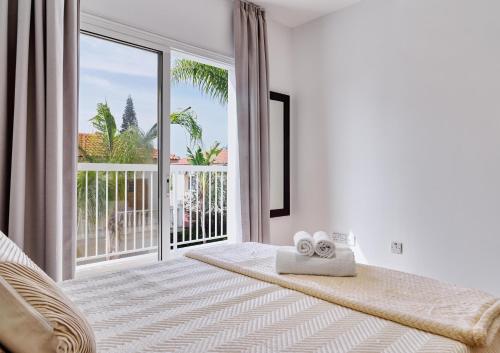a bedroom with a bed with a large window at LuxVillasRentals Ayia Napa in Ayia Napa
