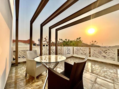 a balcony with a glass table and chairs at FURNISHED APARTMENTS UTAKO ABUJA Between Wuse & Jabi District PLS VIEW Flat PHOTOS B4 BOOKING in Abuja