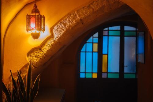 a room with a lamp and a window at Mayelia Ηouse in the old town in Rhodes Town