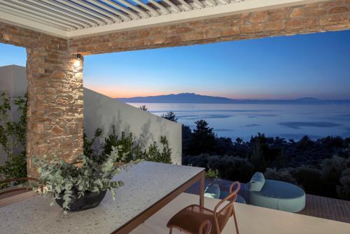 a view from the balcony of a house with a table and chairs at SEDUCTION Villa Thassos in Skala Kallirakhis