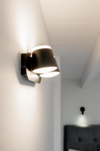 a light on a wall in a room at Villa Scorpios View in Nydri