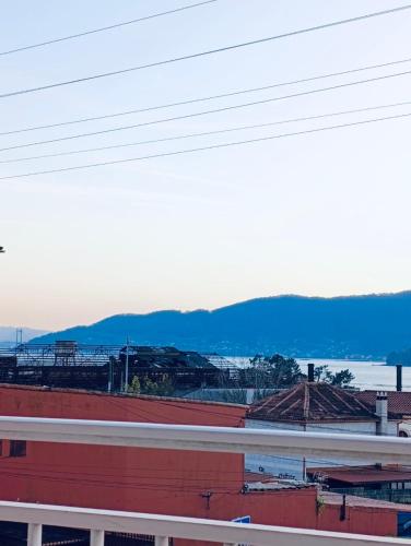 a view of a city with mountains in the background at HyP - Mar y Descanso in Sotomayor