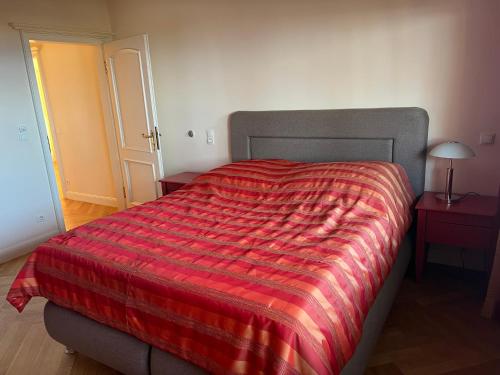 une chambre avec un lit avec une couverture rouge dessus dans l'établissement Dünenhaus Garten, à Timmendorfer Strand